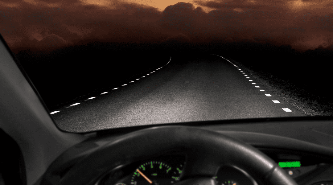 Car driving on a dark road